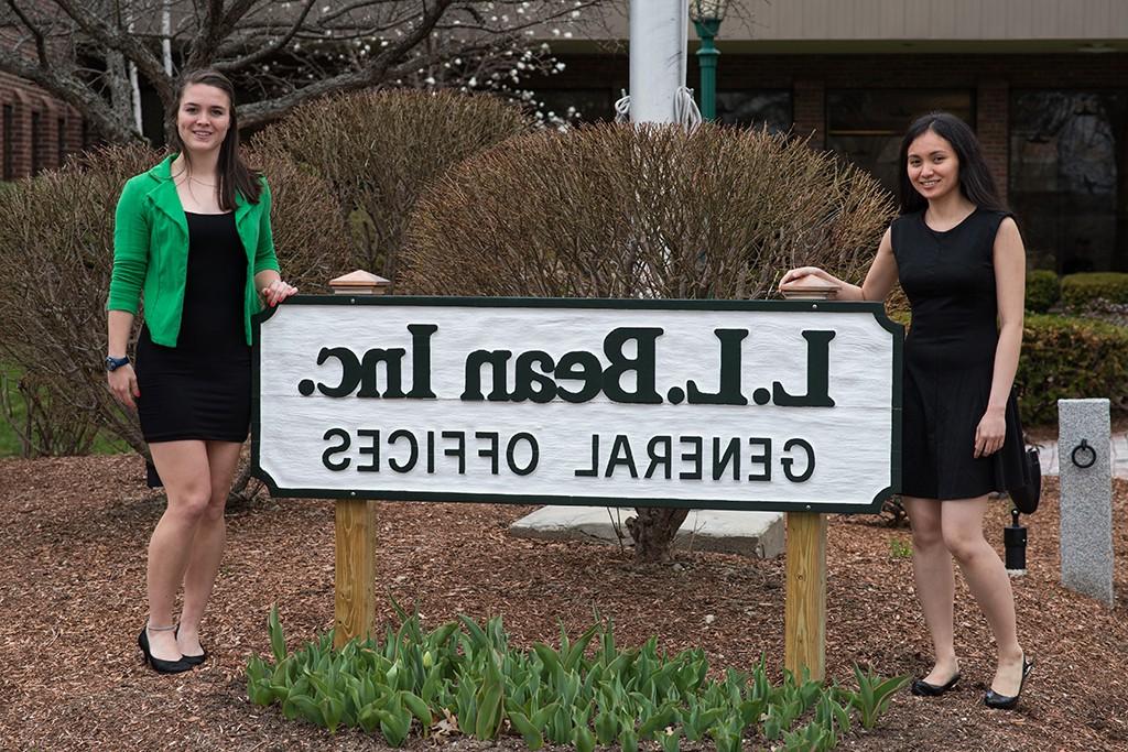 Two U N E students at their internship site, L.L. Bean