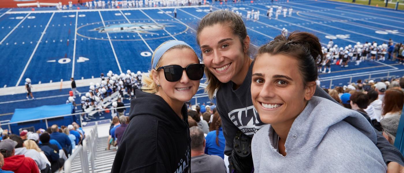 Students pose for a photo in the stands